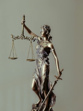 woman-in-gold-dress-holding-sword-figurine.jpg woman in gold dress holding sword figurine