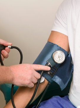 a-doctor-checking-the-blood-pressure-of-a-patient.jpg a doctor checking the blood pressure of a patient